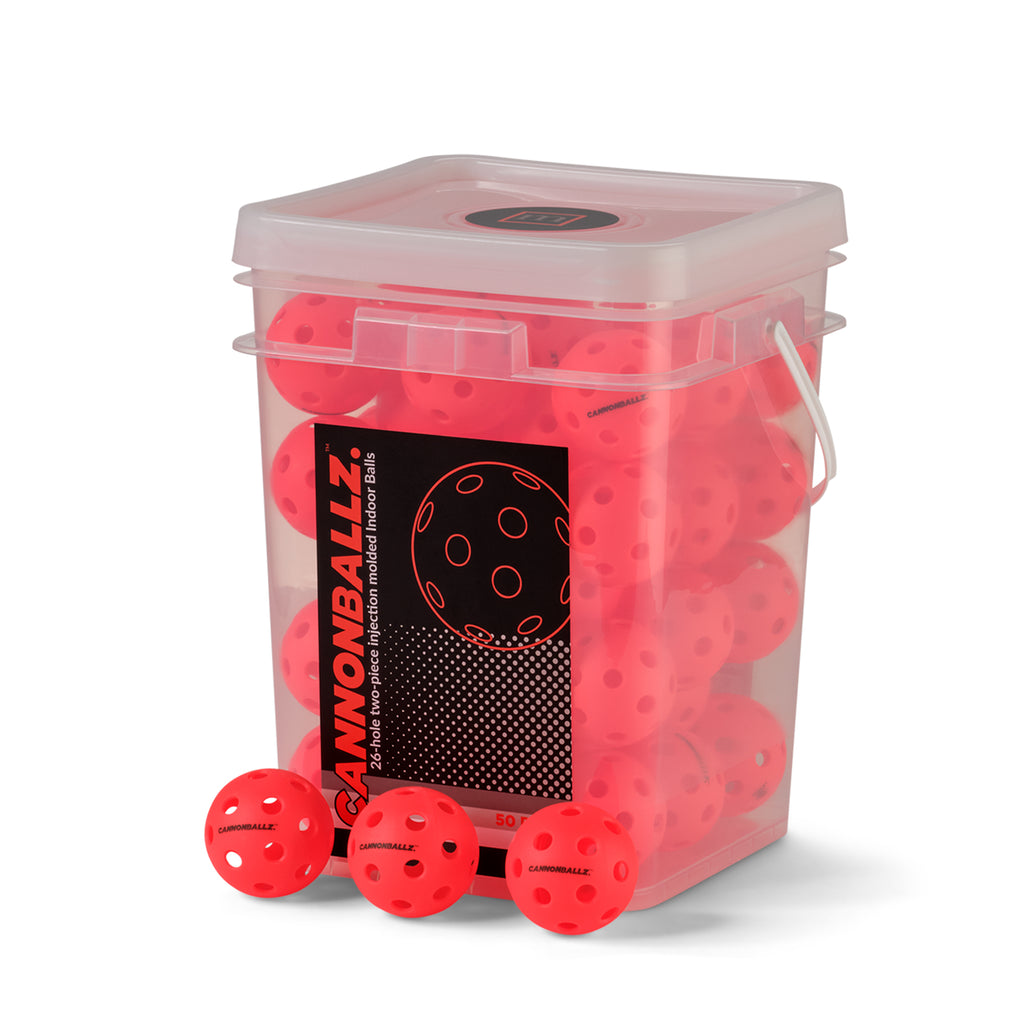 Three red Cannonballz indoor pickleball balls with 26-hole design displayed beneath their 50-pack plastic container.