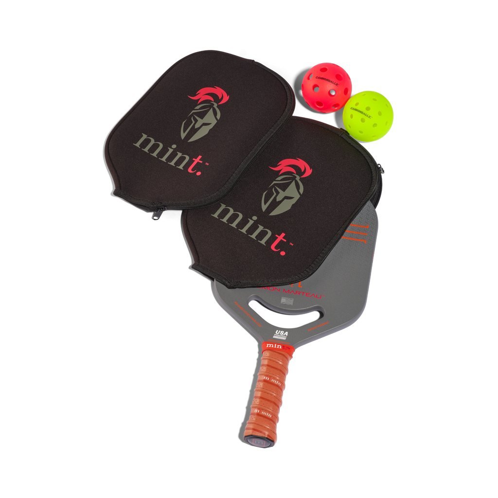Pickleball paddle with black cover and red and green balls on a white background.