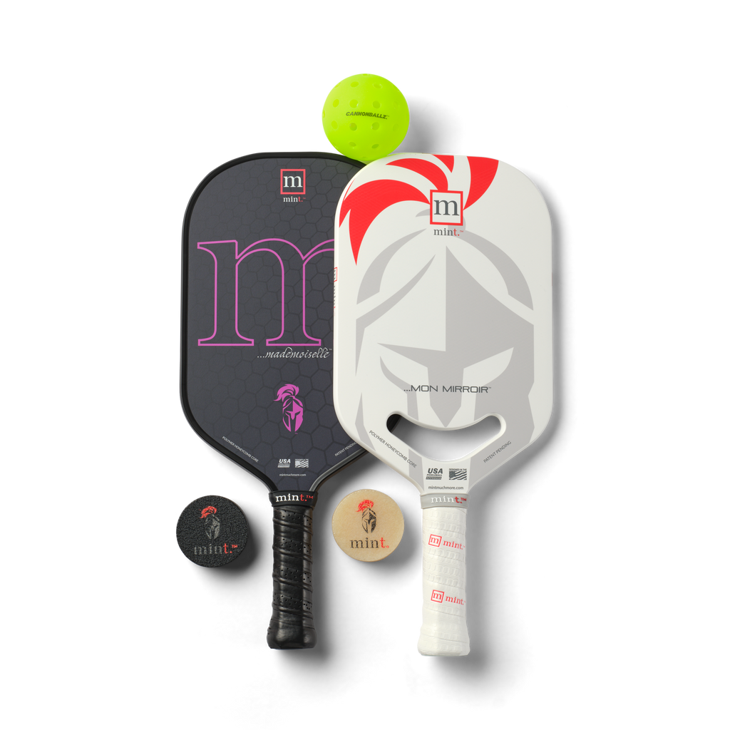 Two pickleball paddles with a ball and two paddle erasers on a white background