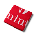 Red jacquard towel on a white background.