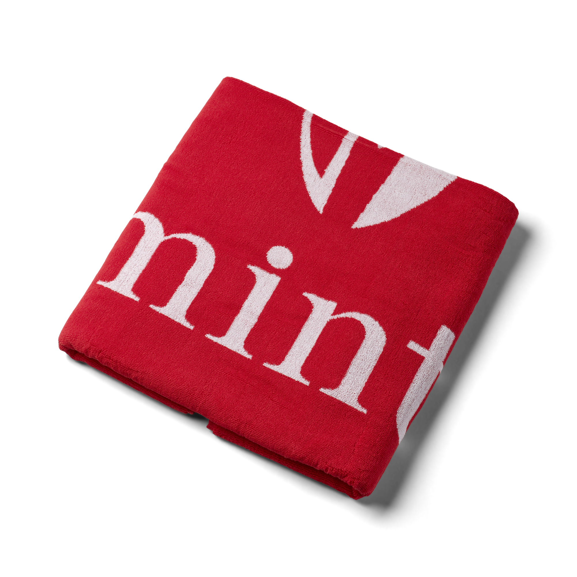 Red jacquard towel on a white background.