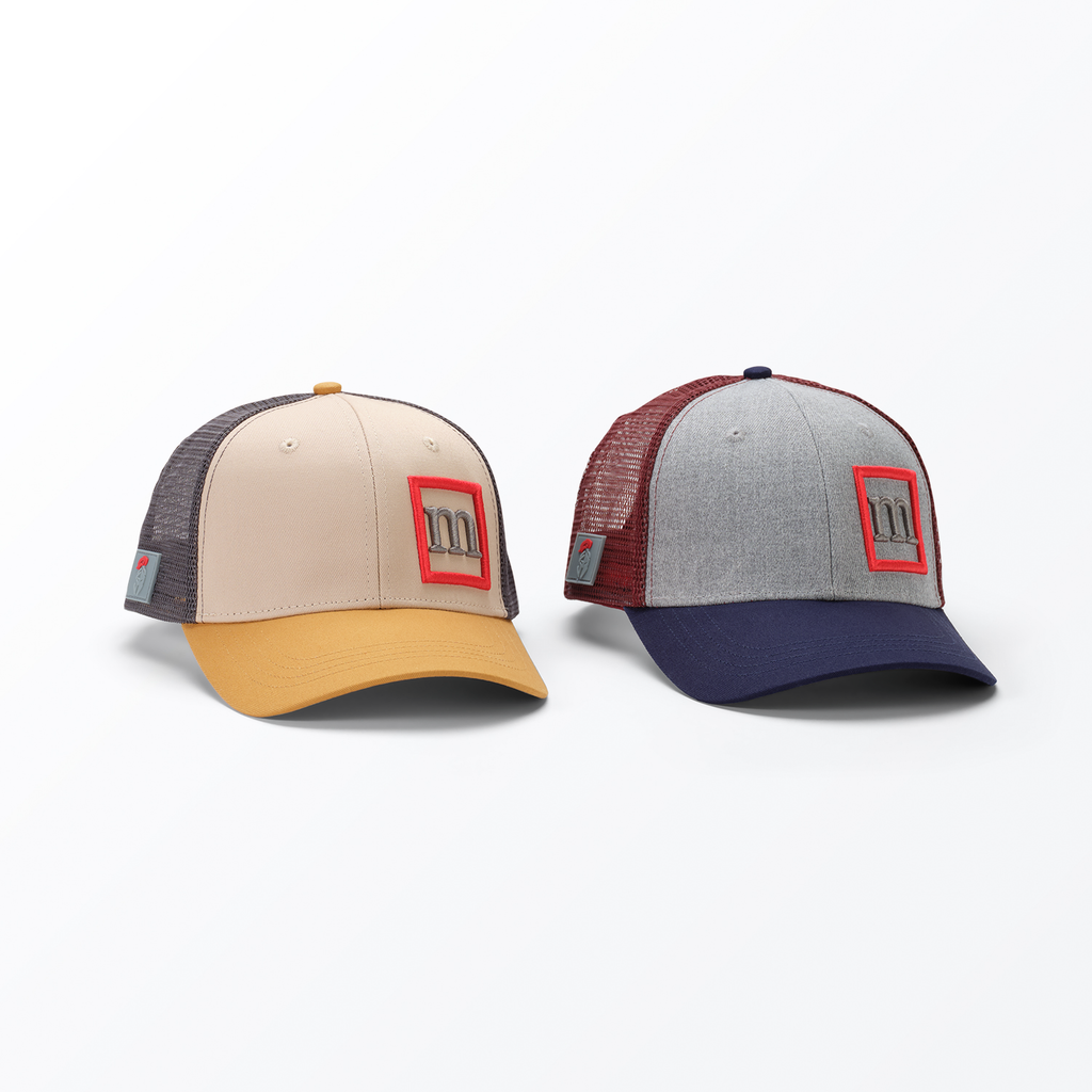 Two baseball caps with red logos on a white background