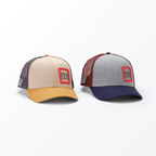 Two baseball caps with red logos on a white background