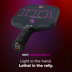 Pickleball paddle with 'm' branding on a purple background