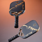 Two Mint Sport Mon Ami black and gold pickleball paddles with an orange and gray gradient background