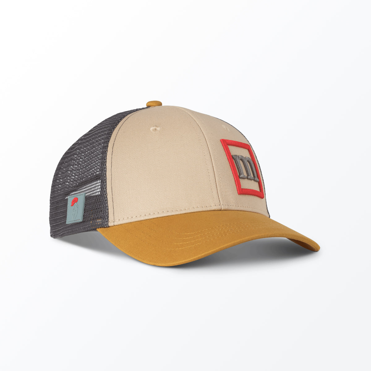 A beige and gray trucker hat with a mesh back and a 3D embroidered logo on the front.
