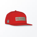 A red trucker hat with a logo that reads '...par excellence' on the front.