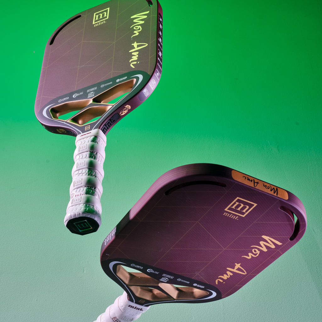 Two Mint Sport Mon Ami pickleball paddles with a green gradient background
