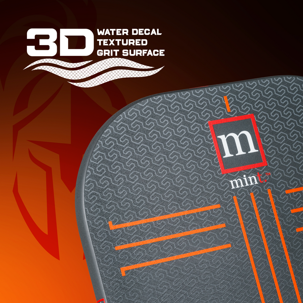 Pickleball racket with textured grip surface and 'mint' branding on an orange and brown gradient background.