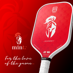 Red pickleball paddle with white logo on a red background, featuring the brand 'mint'.