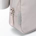 Close-up of a gray-colored Mint Sport belt bag with a zipper on a white background