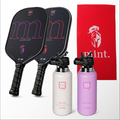 Two pickleball paddles, two water bottles, and a towel with a brand logo on a white background.