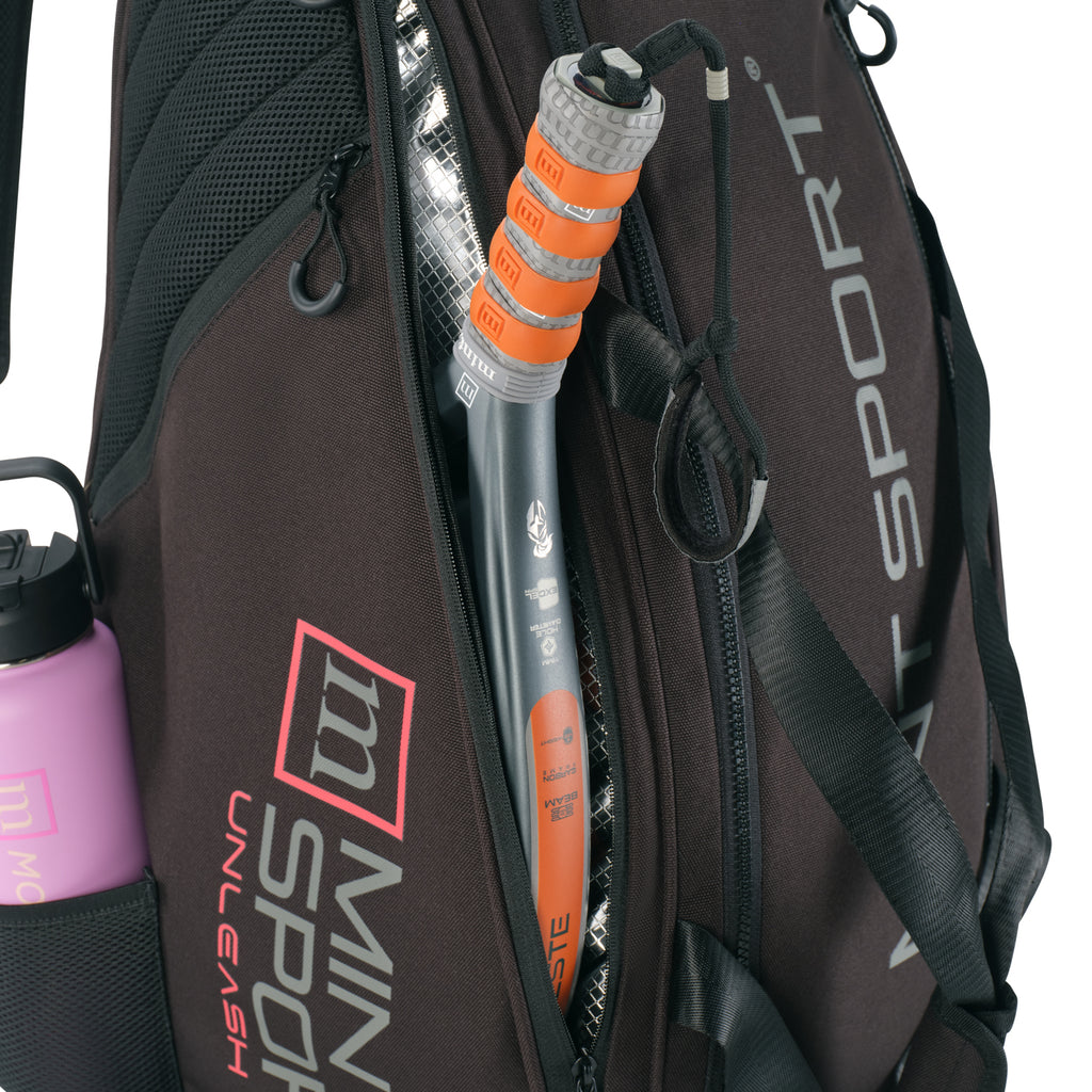 Unleash Tournament Bag in Black, racket sliding into a side racket compartment