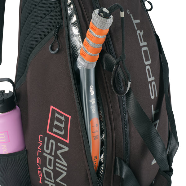 Unleash Tournament Bag in Black, racket sliding into a side racket compartment