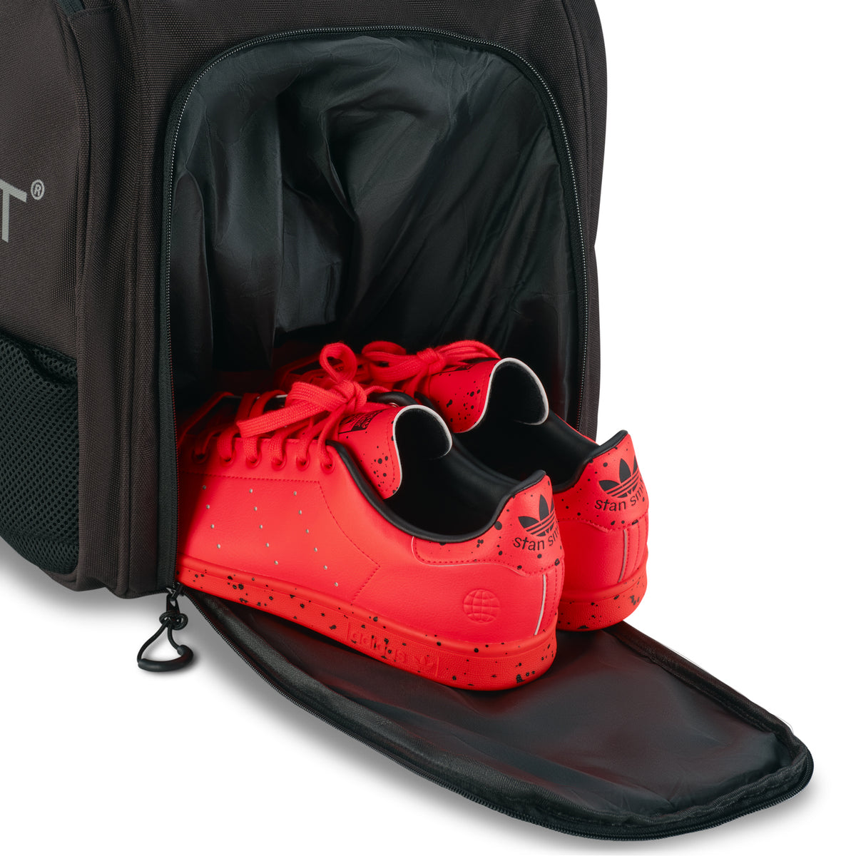 Unleash Tournament Bag in Black, court shoes coming out of the bottom shoe compartment