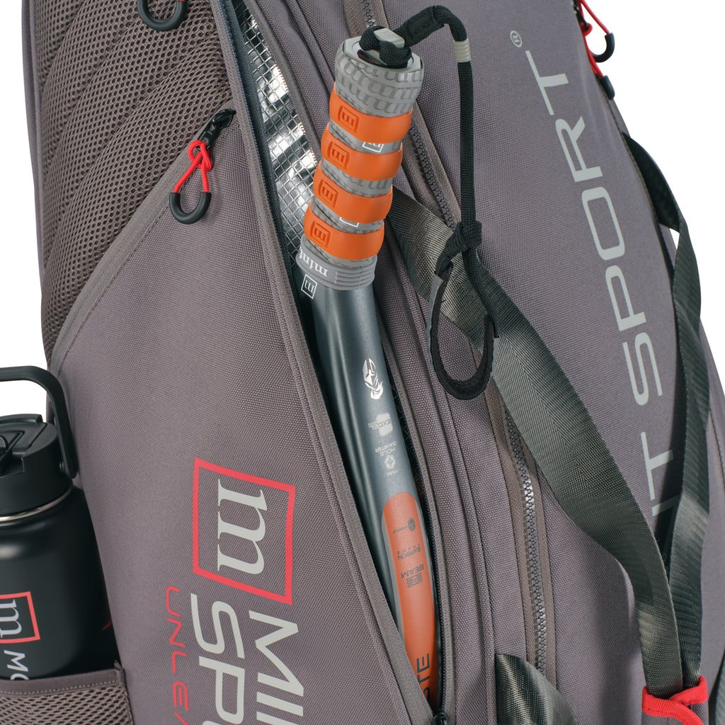 Unleash Tournament Bag in Gray, racket sliding into a side racket compartment