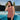 Woman wearing a tank top with a logo by a poolside