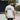 Man wearing a white t-shirt with 'Banger Rally Wrecker' design on a tennis court