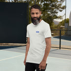 Man wearing a white t-shirt with a logo on a tennis court
