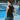 Woman in black tank top with text on a tennis court