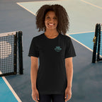 Person wearing a black t-shirt with a logo on a tennis court