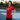 Woman wearing a red t-shirt with a graphic design on a tennis court