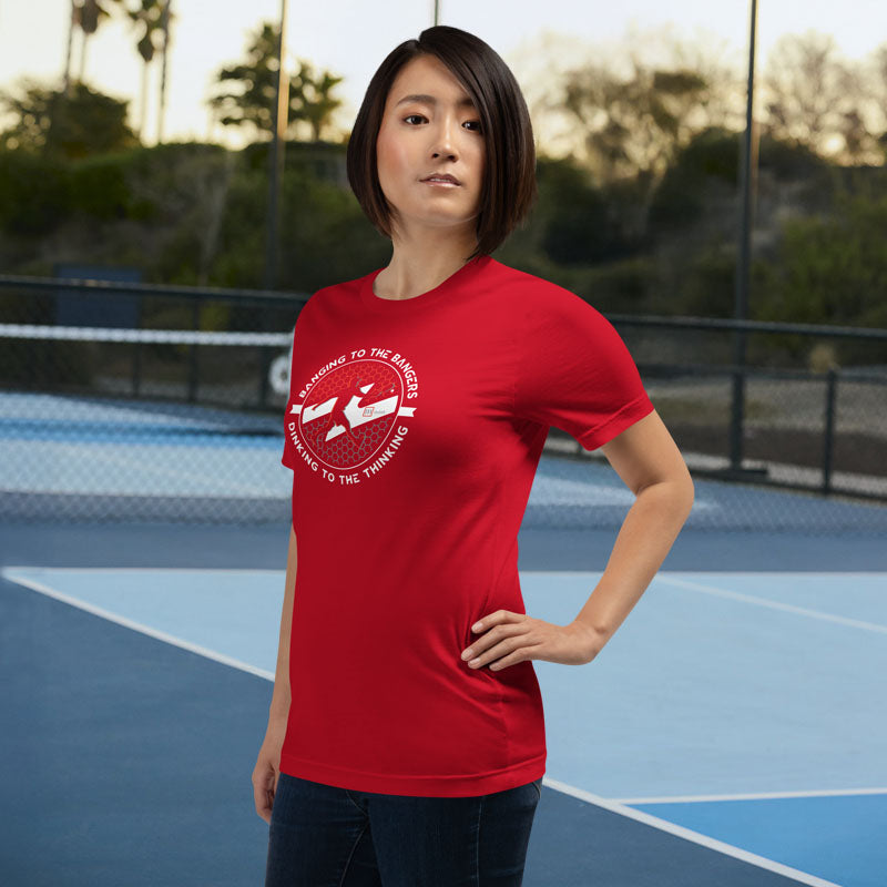Woman wearing a red t-shirt with a graphic design on a tennis court