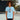 Woman wearing a light blue t-shirt with a graphic design on a tennis court