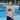Man wearing a gray t-shirt with 'MUCH MORE' text on a tennis court