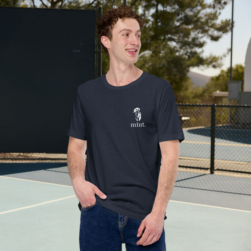 Man wearing a navy blue t-shirt with a logo on a tennis court