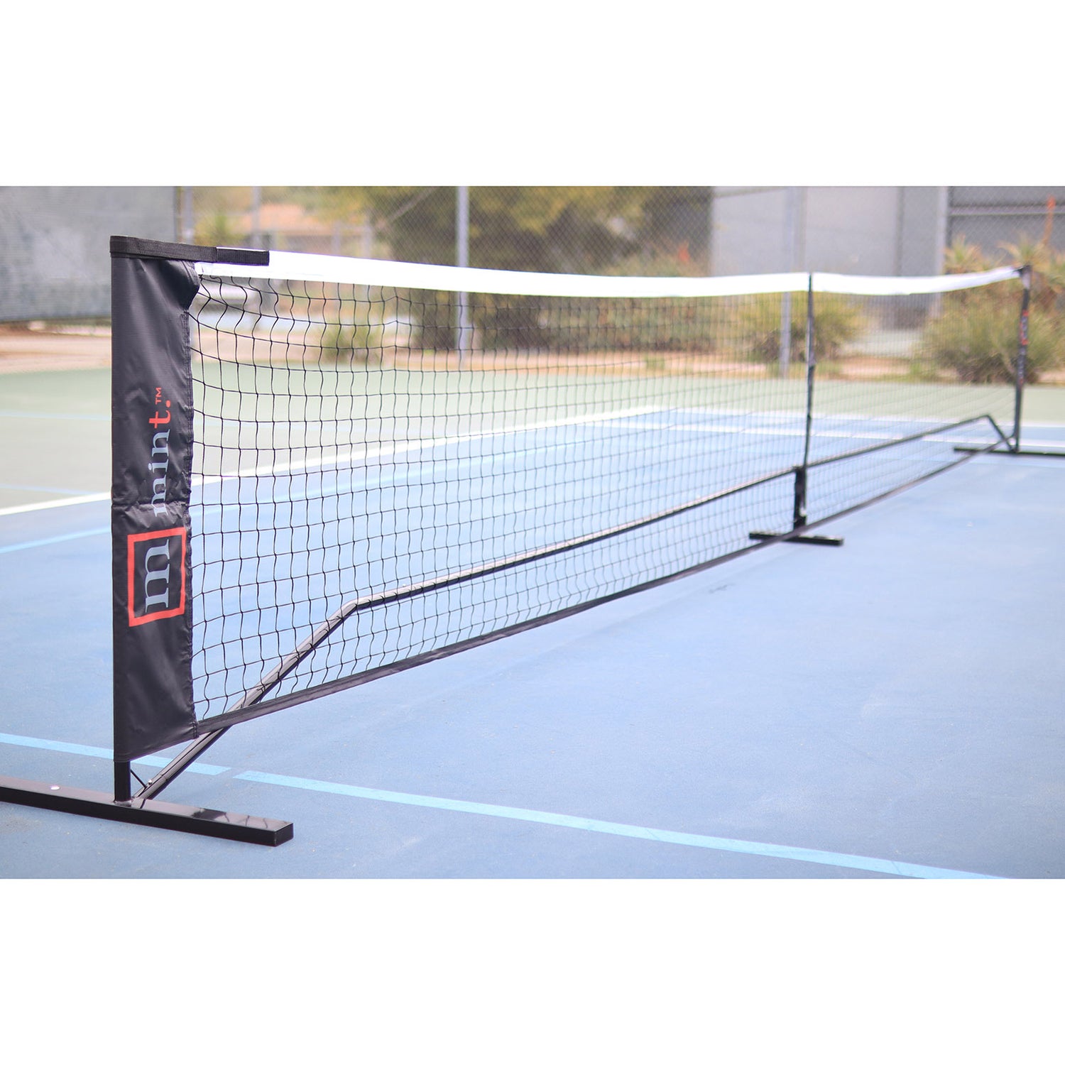 Pickleball net with brand logo on a tennis court