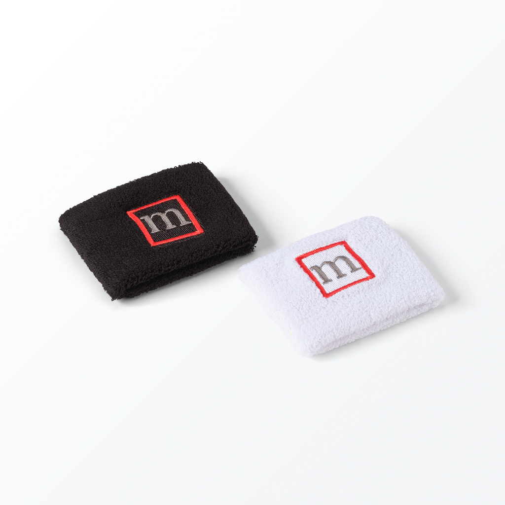 Black and white wristbands with a red 'm' logo on a white background